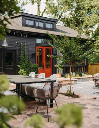 A modern backyard featuring a seating area and a dining area.