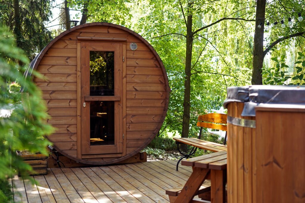 Backyard barrel sauna kit installed on a raised deck